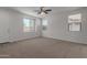 Spacious living room with carpet flooring, neutral walls, and large windows at 812 E Agua Fria Ln, Avondale, AZ 85323