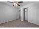 Bedroom with ceiling fan and sliding closet doors at 812 E Agua Fria Ln, Avondale, AZ 85323