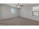 Spacious carpeted bedroom with ceiling fan and window at 812 E Agua Fria Ln, Avondale, AZ 85323