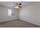 Bright bedroom with ceiling fan and carpeted floor at 812 E Agua Fria Ln, Avondale, AZ 85323