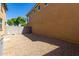 Small backyard with gravel and block wall. Includes AC unit at 836 E Agua Fria Ln, Avondale, AZ 85323