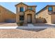 Two-story house with light brown exterior, walkway, and small front yard at 851 E Agua Fria Ln, Avondale, AZ 85323
