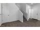 Bright, open entryway with carpeted staircase and flooring at 851 E Agua Fria Ln, Avondale, AZ 85323