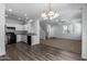 Open kitchen with white cabinets, black appliances, and wood-look flooring at 851 E Agua Fria Ln, Avondale, AZ 85323