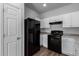Well-equipped kitchen, white cabinets, black appliances, and granite countertops at 851 E Agua Fria Ln, Avondale, AZ 85323
