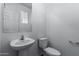 Simple and clean bathroom with a pedestal sink and toilet at 851 E Agua Fria Ln, Avondale, AZ 85323