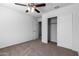 Bright bedroom with ceiling fan and closet at 851 E Agua Fria Ln, Avondale, AZ 85323