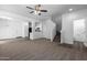 Open living room with carpeted floor, stairs, and kitchen view at 851 E Agua Fria Ln, Avondale, AZ 85323