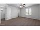Carpeted bedroom with ceiling fan and access to another room at 851 E Agua Fria Ln, Avondale, AZ 85323