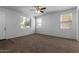 Spacious living room with carpeted floor and ceiling fan at 851 E Agua Fria Ln, Avondale, AZ 85323
