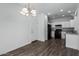 Modern kitchen with white cabinets and black appliances at 851 E Agua Fria Ln, Avondale, AZ 85323