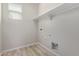 Laundry room with white shelving and vinyl flooring at 927 E Agua Fria Ln, Avondale, AZ 85323