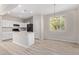 Modern kitchen with white cabinets, island, and breakfast area at 927 E Agua Fria Ln, Avondale, AZ 85323