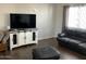 Relaxing living room with dark leather furniture and wood-look floors at 1527 E Germann Rd, San Tan Valley, AZ 85140