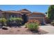 One-story home with brown garage door and desert landscaping at 15959 W Hearn Rd, Surprise, AZ 85379