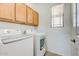 Laundry room with washer, dryer, and overhead cabinets at 11500 E Cochise Dr # 2090, Scottsdale, AZ 85259