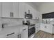 Modern kitchen with white cabinets and stainless steel appliances at 10103 E Plata Ave, Mesa, AZ 85212