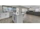 Modern kitchen with white cabinets, island, and stainless steel appliances at 10103 E Plata Ave, Mesa, AZ 85212