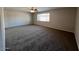 Spacious living room featuring neutral carpeting and a large window at 1709 W Tonto Ln, Phoenix, AZ 85027