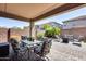 Covered patio with seating area, dining table, and grill at 12219 W Prickly Pear Trl, Peoria, AZ 85383