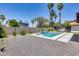 Relaxing backyard pool with a waterfall feature and sitting area at 2616 S Extension Rd, Mesa, AZ 85210