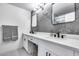 Modern bathroom with double vanity, gray textured wall, and hexagon tile floor at 2616 S Extension Rd, Mesa, AZ 85210