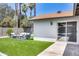 Artificial turf backyard with patio furniture and sliding glass door access at 2616 S Extension Rd, Mesa, AZ 85210