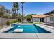 Modern rectangular pool with a built-in bench and waterfall feature at 2616 S Extension Rd, Mesa, AZ 85210