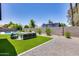 Private backyard featuring artificial turf, a pool, and modern seating at 2616 S Extension Rd, Mesa, AZ 85210