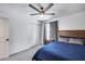 Cozy bedroom with a ceiling fan, ample closet space, and blue bedding at 2616 S Extension Rd, Mesa, AZ 85210