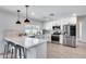 Modern kitchen with white cabinets, stainless steel appliances, and quartz countertops at 2616 S Extension Rd, Mesa, AZ 85210