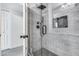 Updated bathroom with walk-in shower, gray tile, and pebble floor at 2616 S Extension Rd, Mesa, AZ 85210