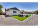 Landscaped backyard with artificial turf, seating area and a pool at 2616 S Extension Rd, Mesa, AZ 85210