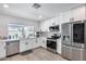 Modern kitchen with white cabinets, stainless steel appliances, and quartz countertops at 2616 S Extension Rd, Mesa, AZ 85210