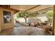 Relaxing patio area with stone tile flooring, potted plants, and a small fountain at 26006 S Brentwood Dr, Sun Lakes, AZ 85248