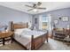 Cozy bedroom with wooden furniture and a large window offering natural light at 20102 W Camelback Rd, Litchfield Park, AZ 85340