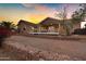 Home exterior showcasing a large deck, stone wall and hot tub at 77 S Arroya Rd, Apache Junction, AZ 85119