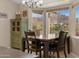 Charming dining area with a view and wood table set for four at 77 S Arroya Rd, Apache Junction, AZ 85119