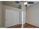 Bedroom with wood floor, ceiling fan, and large closet at 10801 W Palm Ln, Avondale, AZ 85392