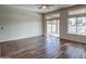 Living room with hardwood floors, ceiling fan, and sliding glass doors to patio at 10801 W Palm Ln, Avondale, AZ 85392