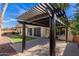 Backyard with pergola, grass, and brick pavers at 17392 W Grant St, Goodyear, AZ 85338