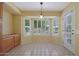 Bright kitchen nook with built-in cabinets and view to backyard at 13818 W Greenview Dr, Sun City West, AZ 85375