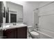 Clean bathroom with tub, shower, and dark brown vanity at 23748 W Hilton Ave, Buckeye, AZ 85326