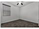 Bright bedroom with ceiling fan and neutral carpeting at 23748 W Hilton Ave, Buckeye, AZ 85326