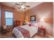 Cozy bedroom with double bed, ceiling fan, and wood furniture at 20377 W Terrace Ln, Buckeye, AZ 85396