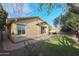 Landscaped backyard with a brick patio and grassy area at 20377 W Terrace Ln, Buckeye, AZ 85396