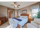 Main bedroom with king bed, sitting area, and ceiling fan at 20377 W Terrace Ln, Buckeye, AZ 85396