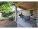 Covered patio with outdoor seating, surrounded by lush landscaping at 20377 W Terrace Ln, Buckeye, AZ 85396