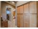 Home hallway with built-in wooden cabinets and carpet flooring at 20377 W Terrace Ln, Buckeye, AZ 85396