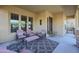 Relaxing front porch featuring comfortable seating and a patterned rug at 20377 W Terrace Ln, Buckeye, AZ 85396